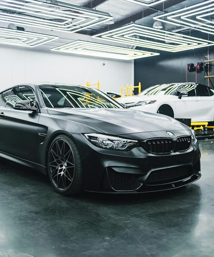 Contemporary black automobile standing in garage
